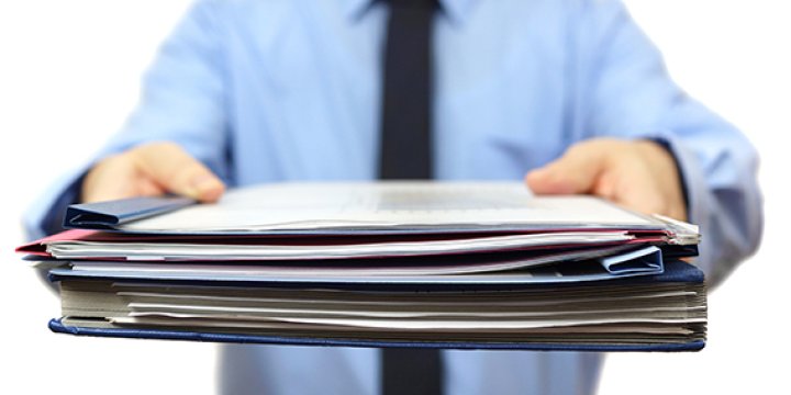 Man holding stack of papers
